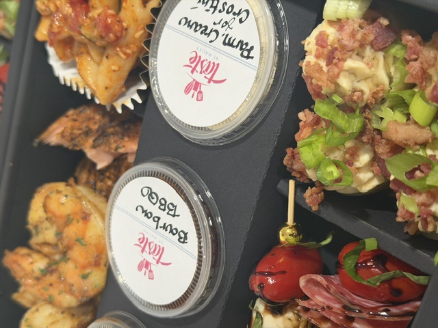 Taste by Malika catered platter with seafood, vegetables, and sauces